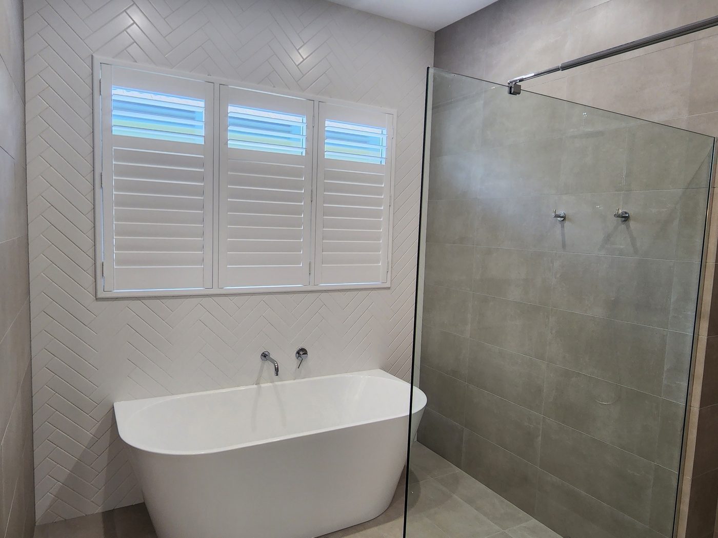 Custom plantation shutters installed in a ensuite — Melbourne property