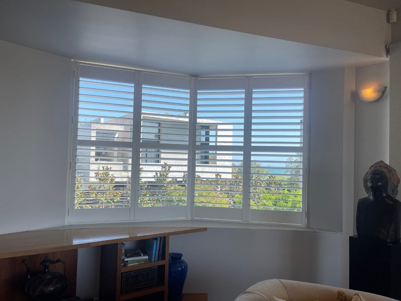 Wide-blade plantation shutters in an open Melbourne living area