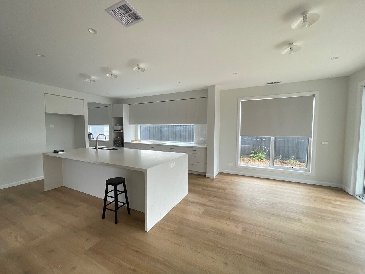 Roller blinds installed throughout the living, dining and kitchen areas of a Melbourne home