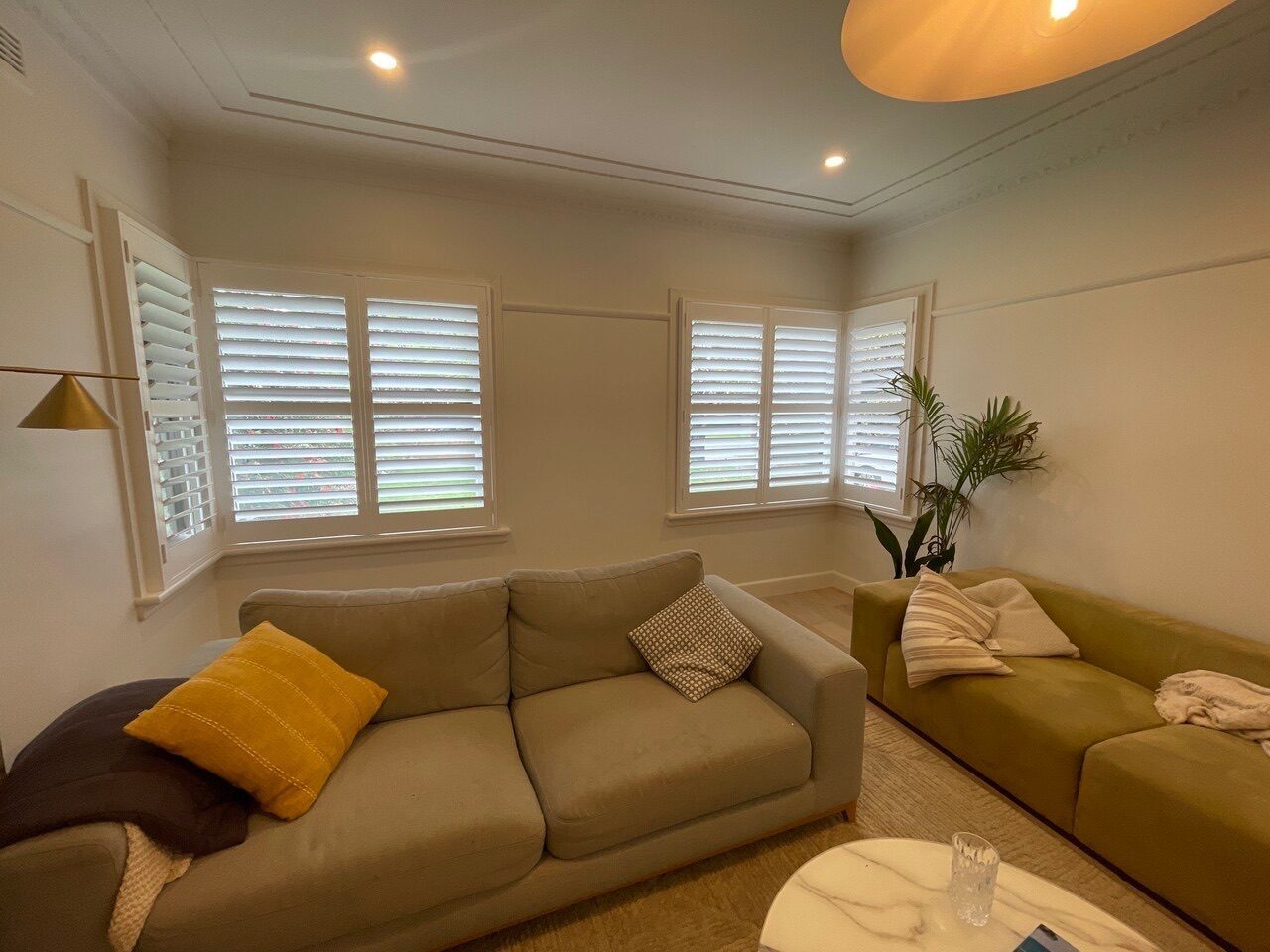 Split tilt plantation shutters in a modern Melbourne living room