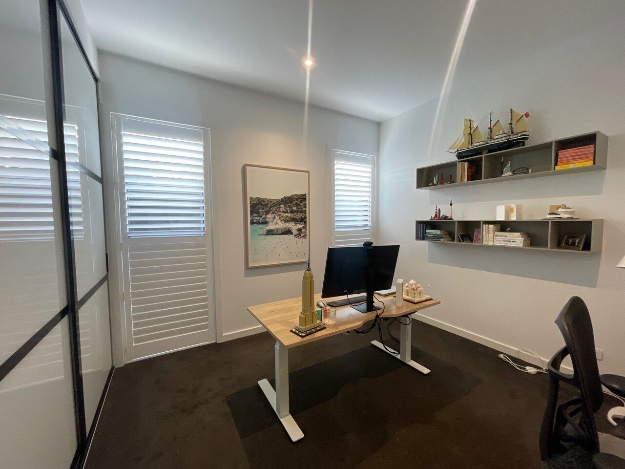 Custom plantation shutters installed in a study — Melbourne property