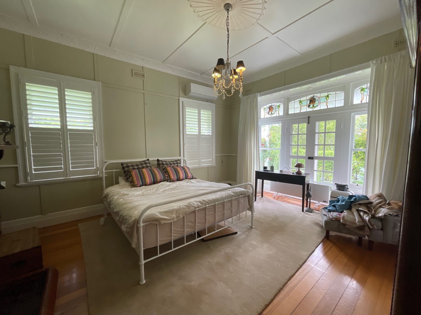 Plantation shutters with wide louvres custom made for a guest bedroom — Melbourne townhouse