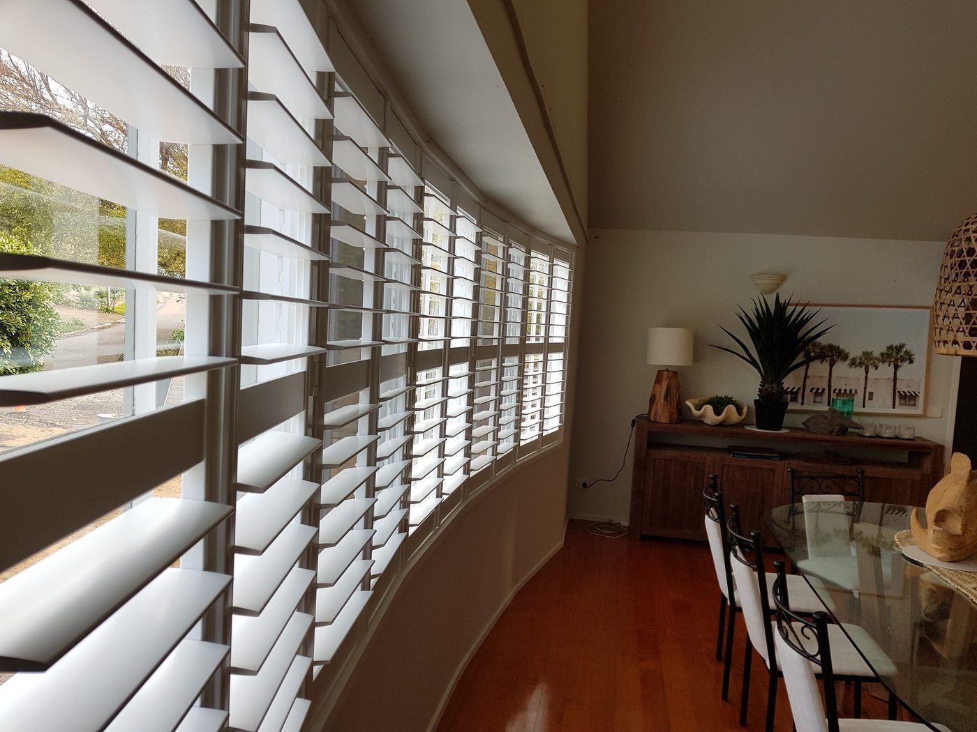 Bi-fold plantation shutters installed in a living room — Melbourne residence