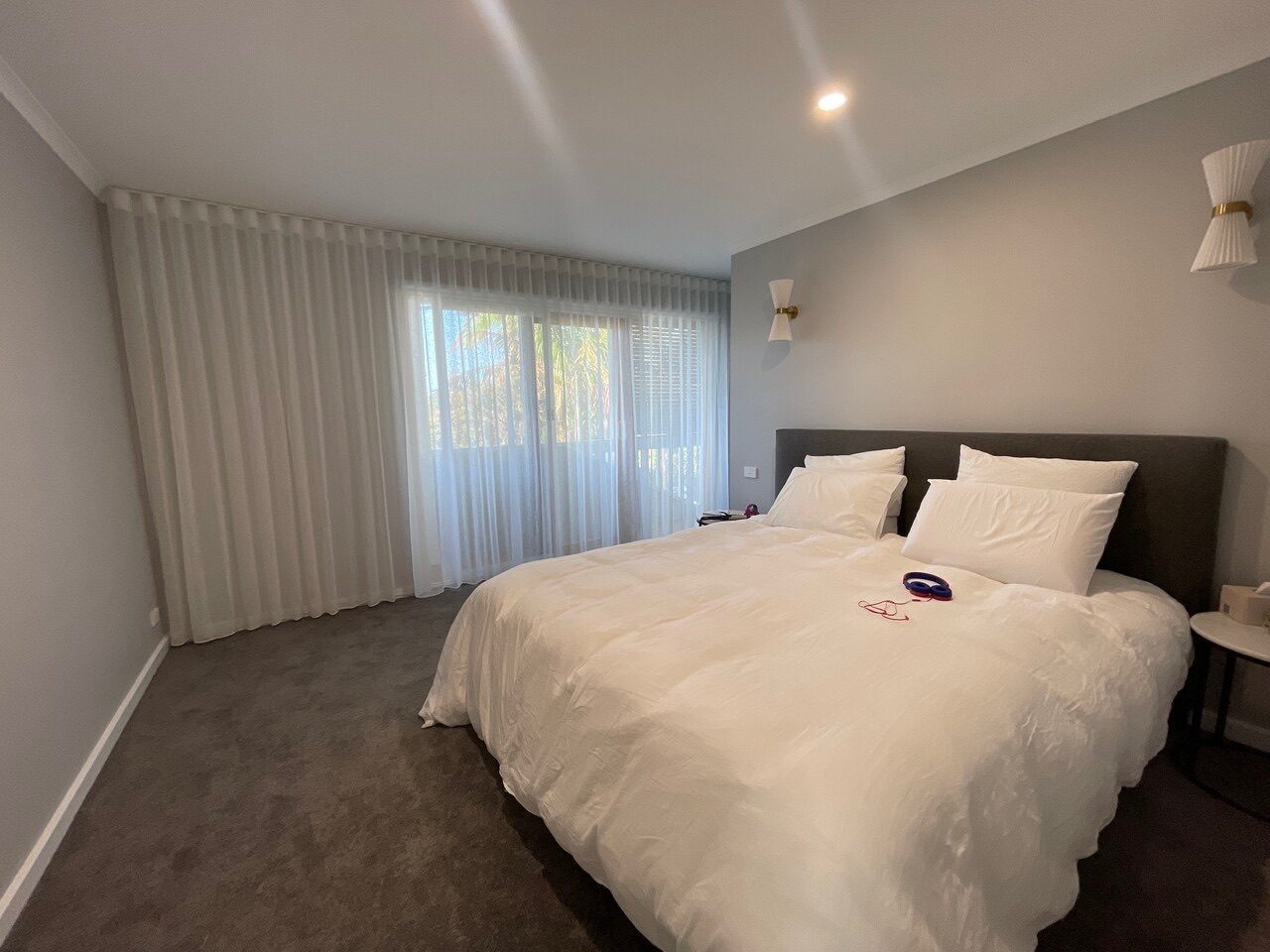 Sunscreen roller blinds and blockout curtains custom made for a guest bedroom — modern Melbourne home