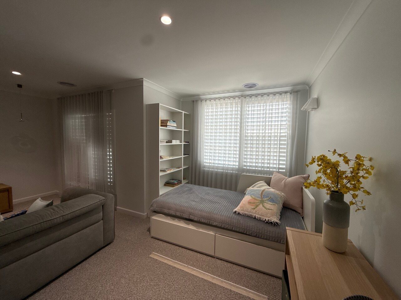 S-fold curtains paired with roller blinds in a Melbourne living area