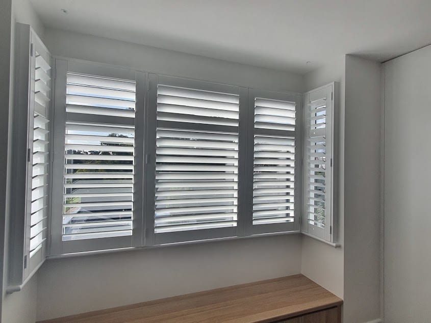 Plantation shutters with track system in a Melbourne living room