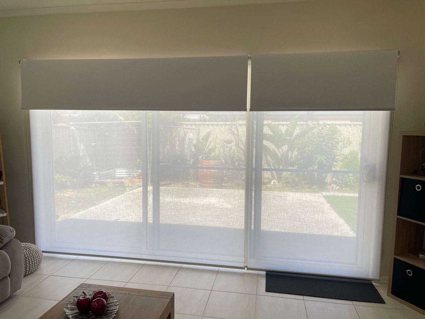 Sunscreen roller blinds custom made for a living area — modern Melbourne home