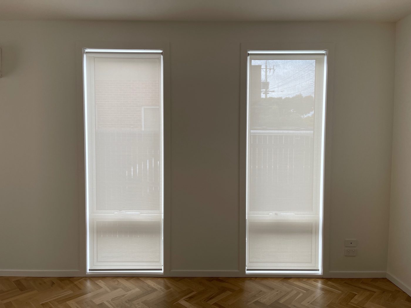 Custom roller blinds installed in a master bedroom — Melbourne apartment