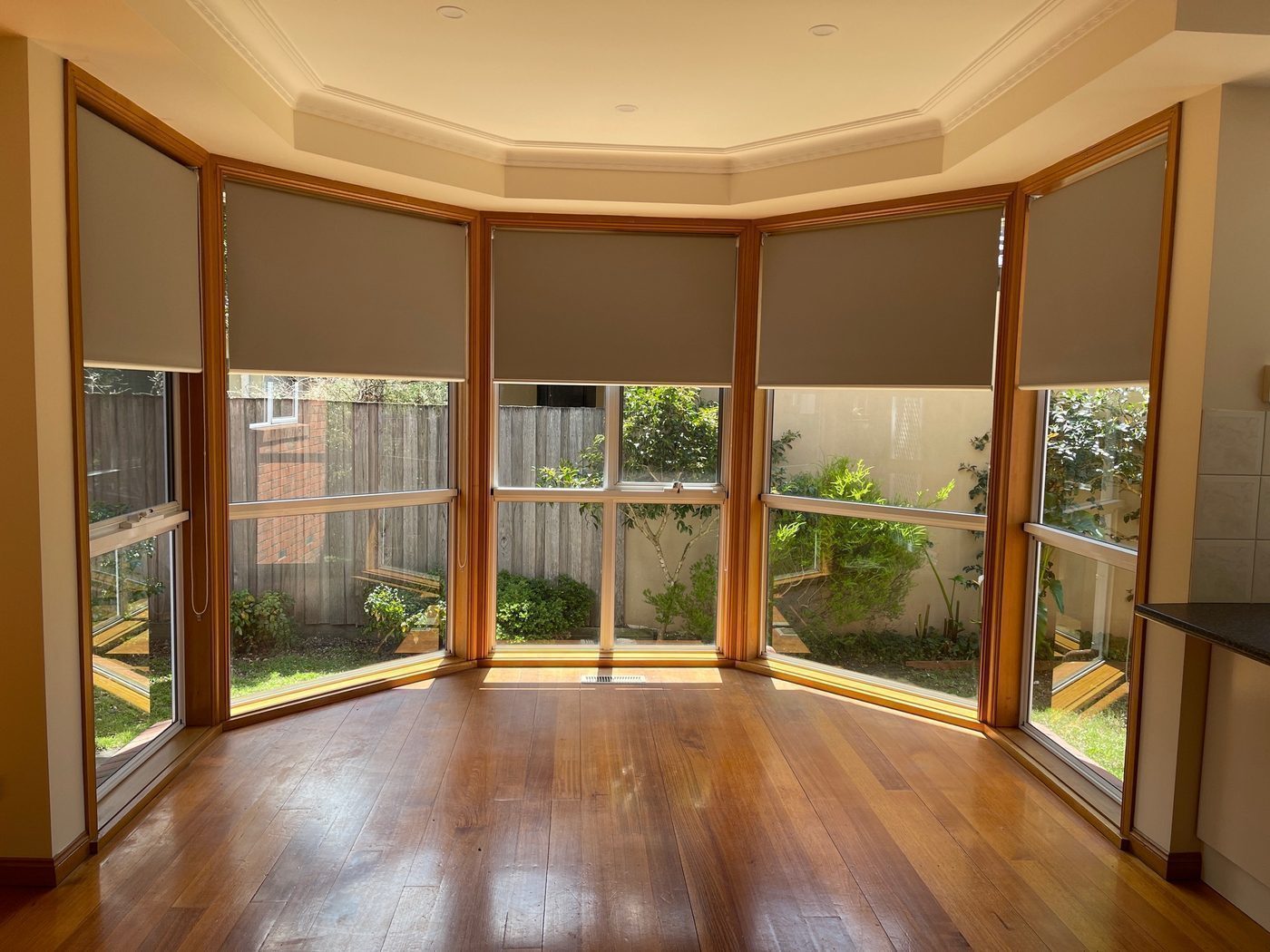 Custom roller blinds installed in a lounge room — Melbourne residence