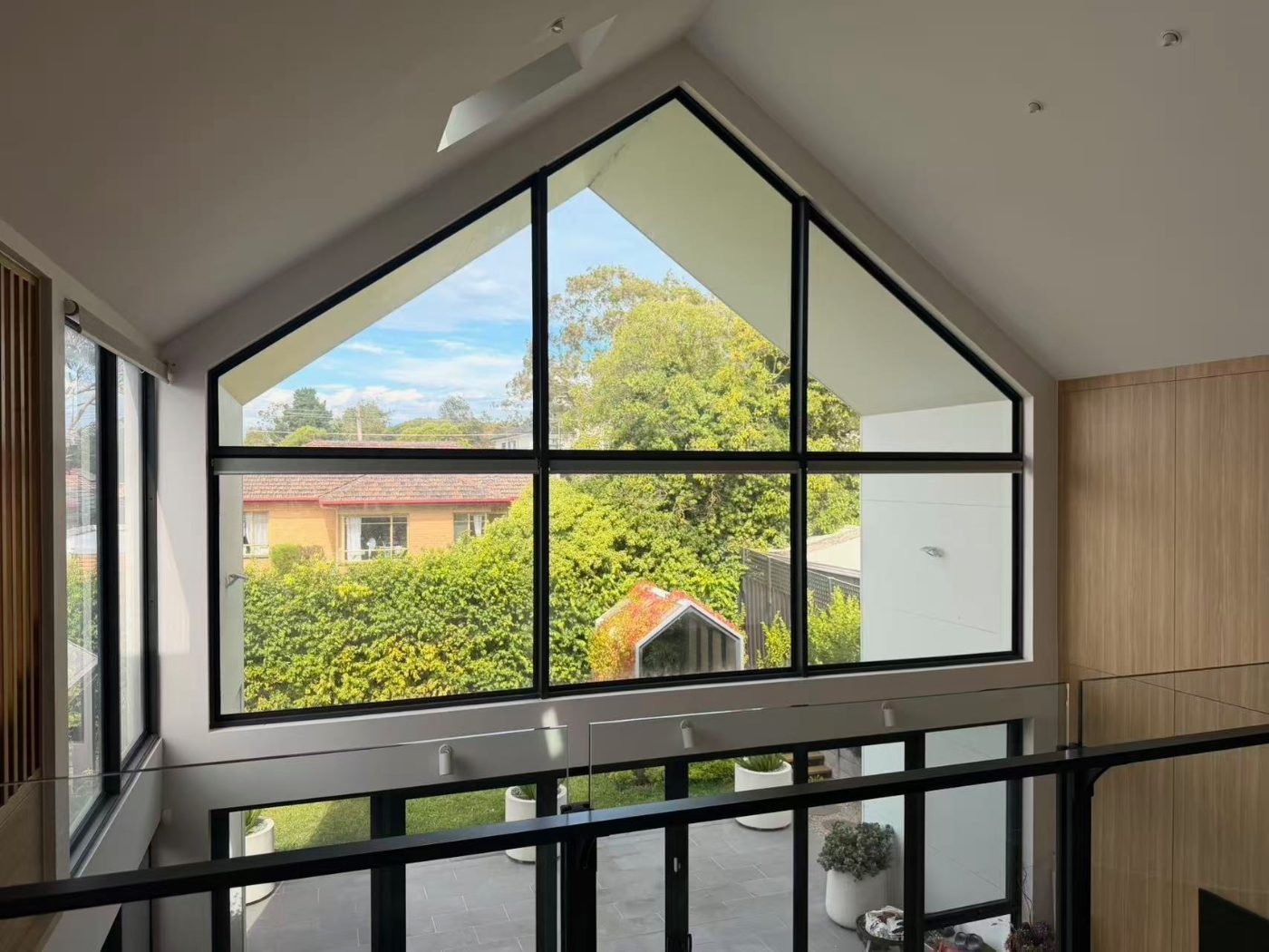 Motorised roller blinds in a Melbourne living room, controlled by remote