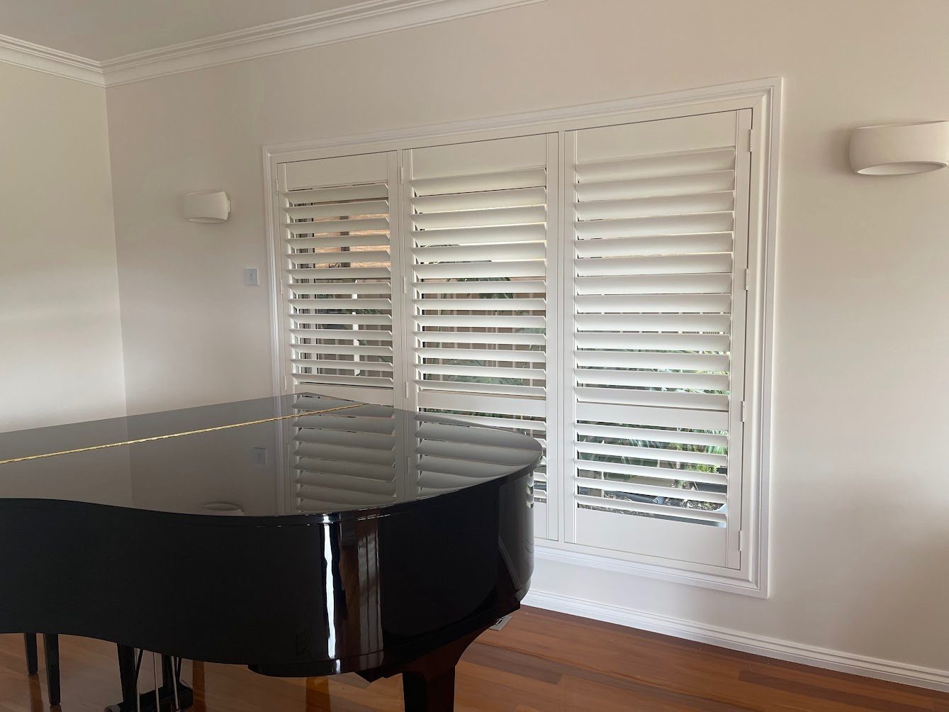 Full-height plantation shutters in a main living room — contemporary Melbourne home
