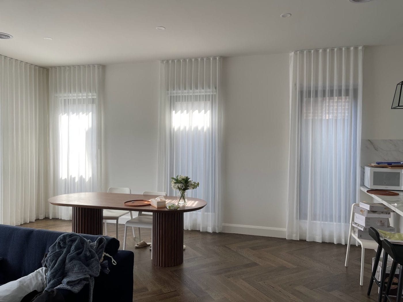 Sheer curtains softening a Melbourne living and dining area