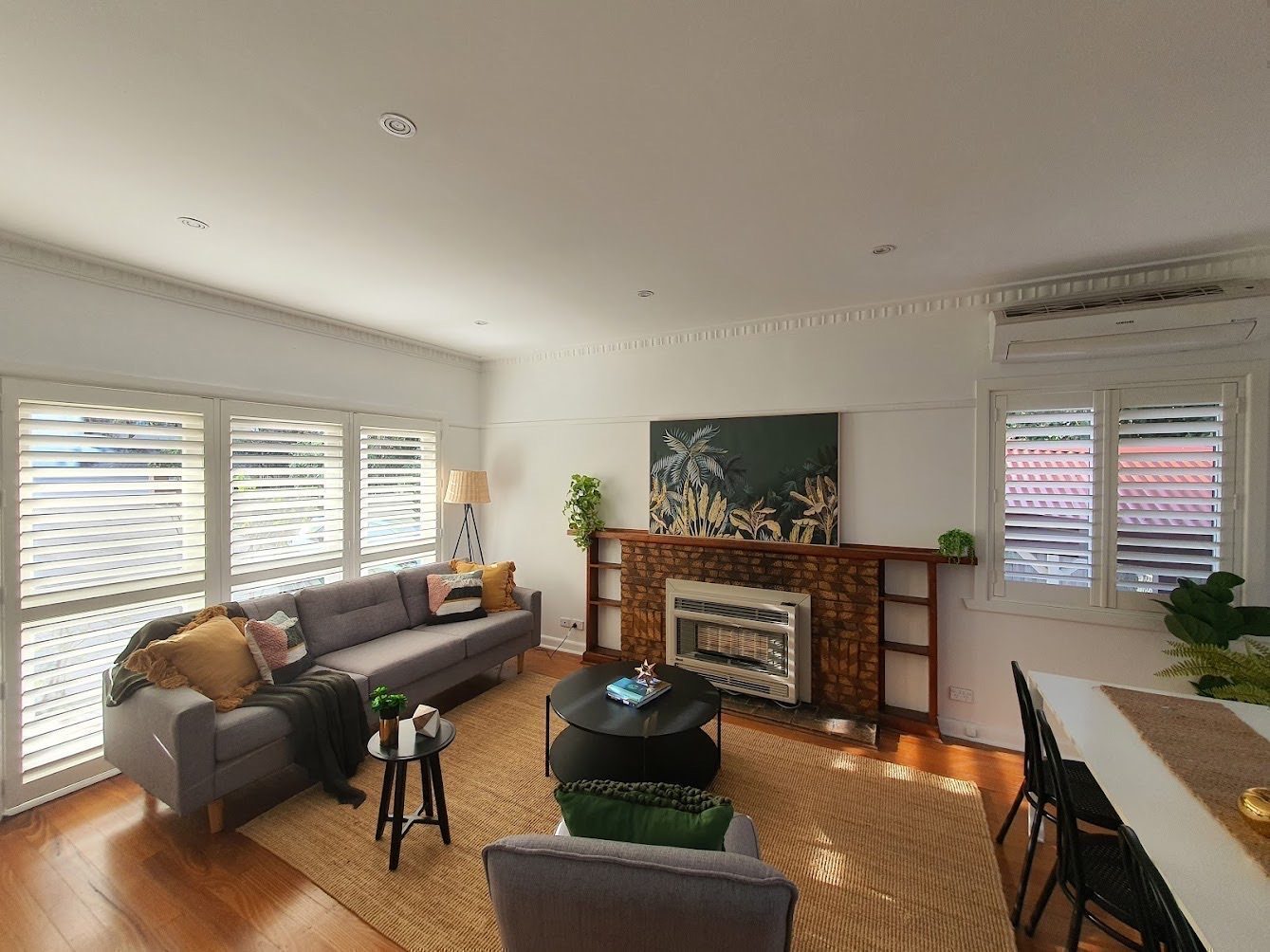 Timber-look plantation shutters custom made for a open-plan living area — modern Melbourne home