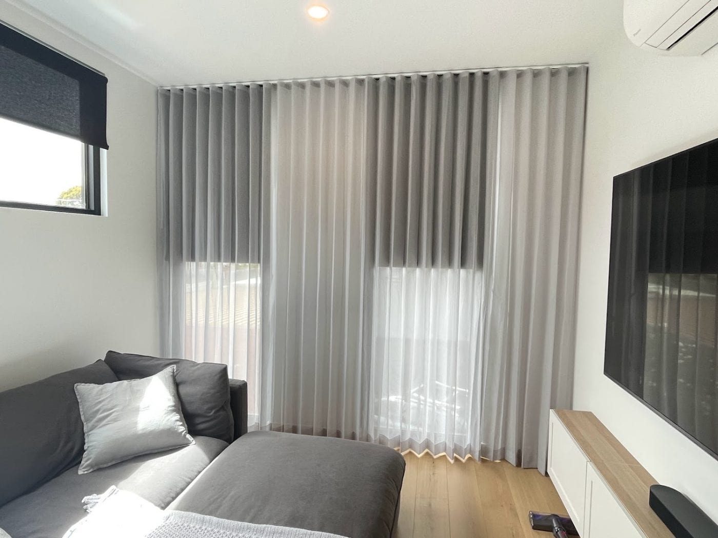 Sheer curtains and blockout roller blinds in a contemporary Melbourne living space