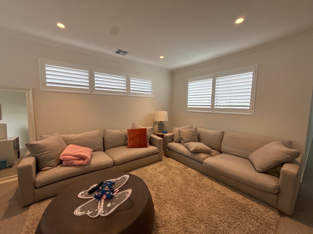 Custom plantation shutters fitted in a living room — Melbourne home