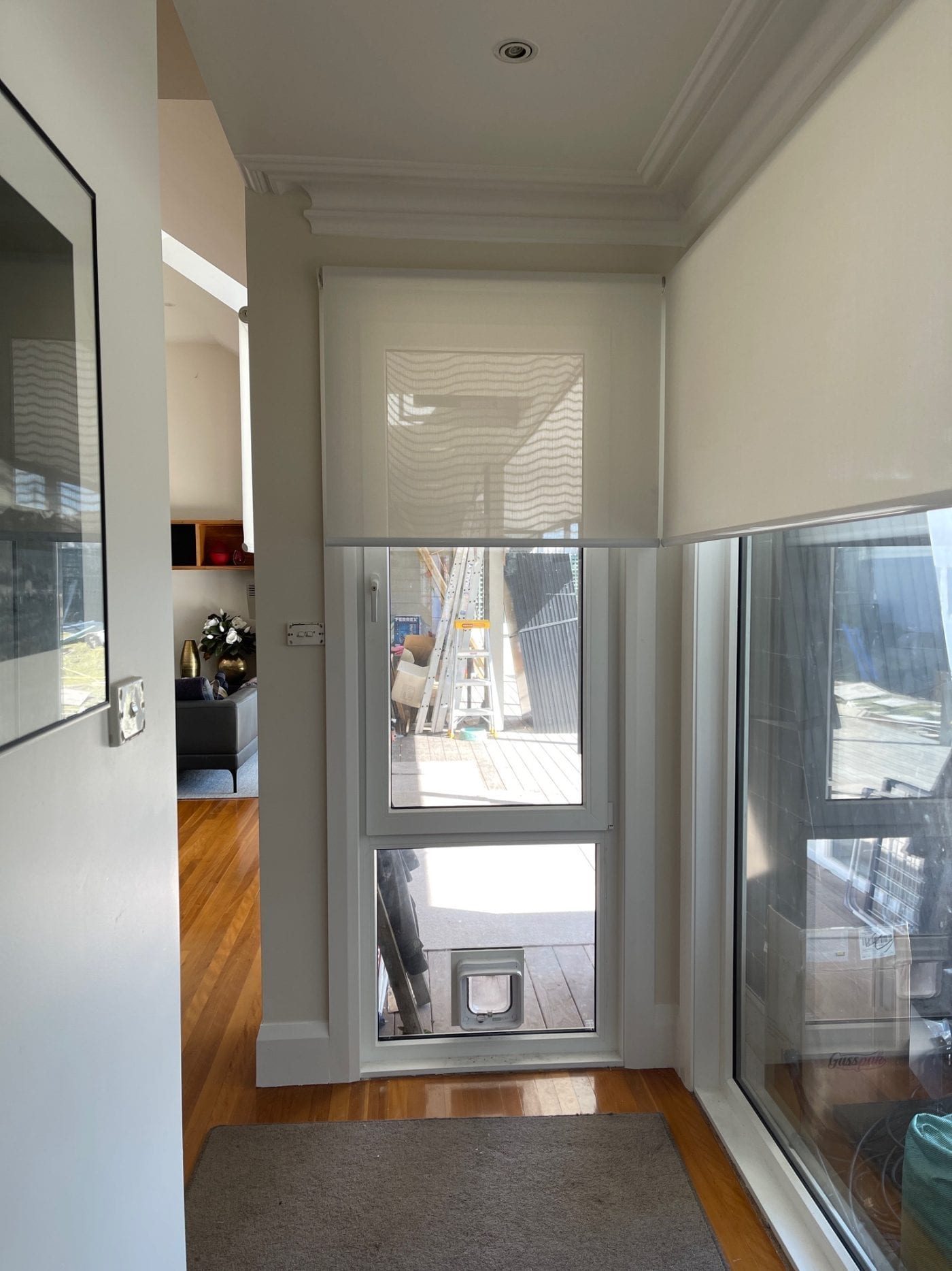 Blockout roller blinds with side channels in a Melbourne living room