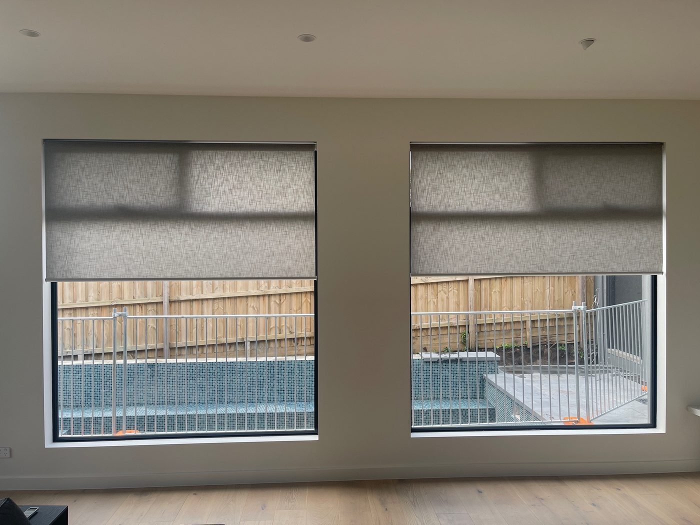 Blockout roller blinds fitted in a open-plan living area — Melbourne house