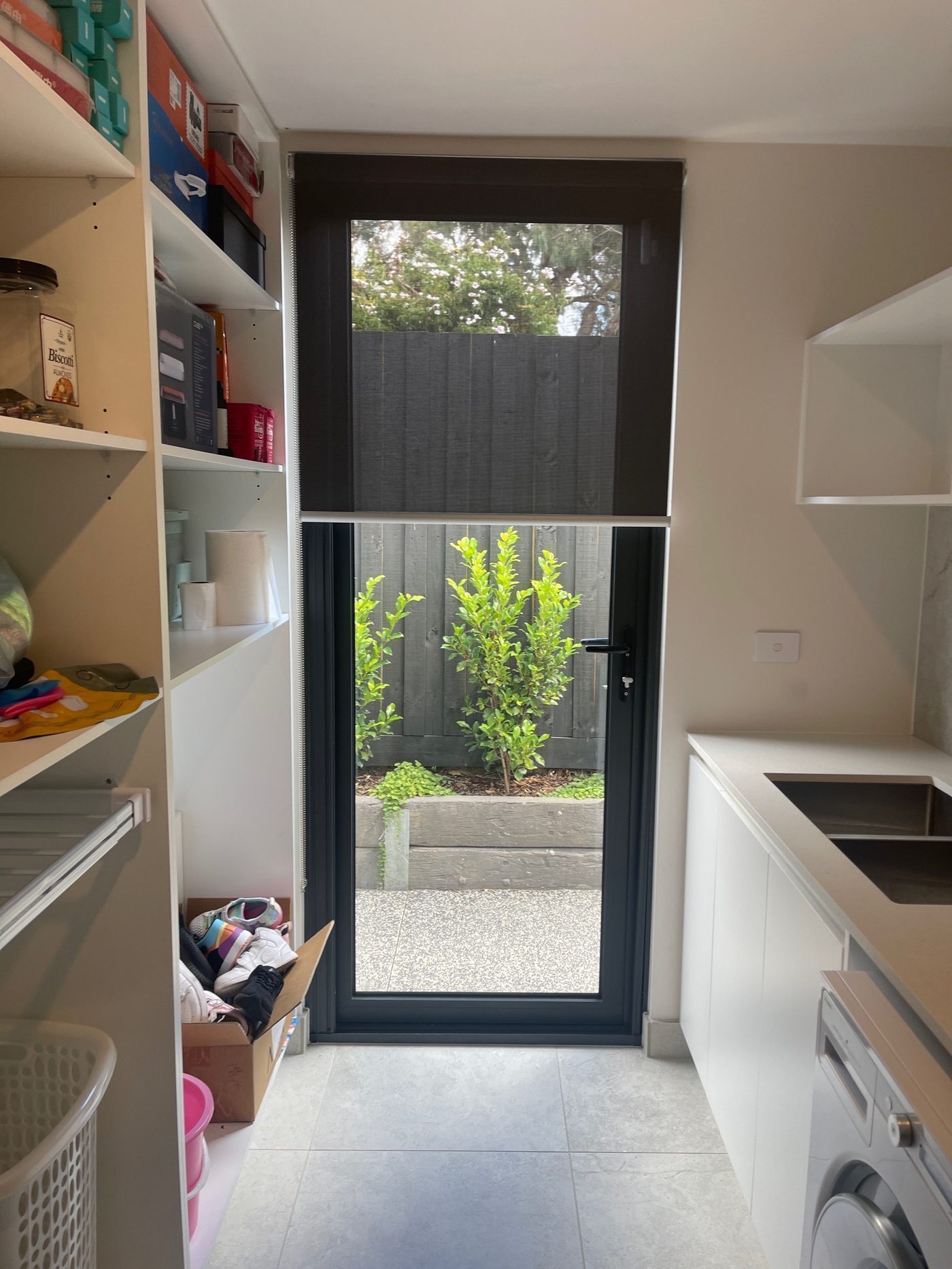 Blockout roller blinds fitted in a kitchen — contemporary Melbourne home
