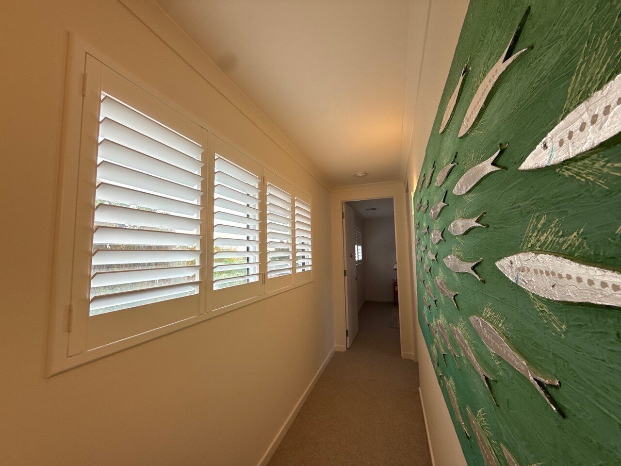 White plantation shutters custom made for a lounge room — Melbourne townhouse