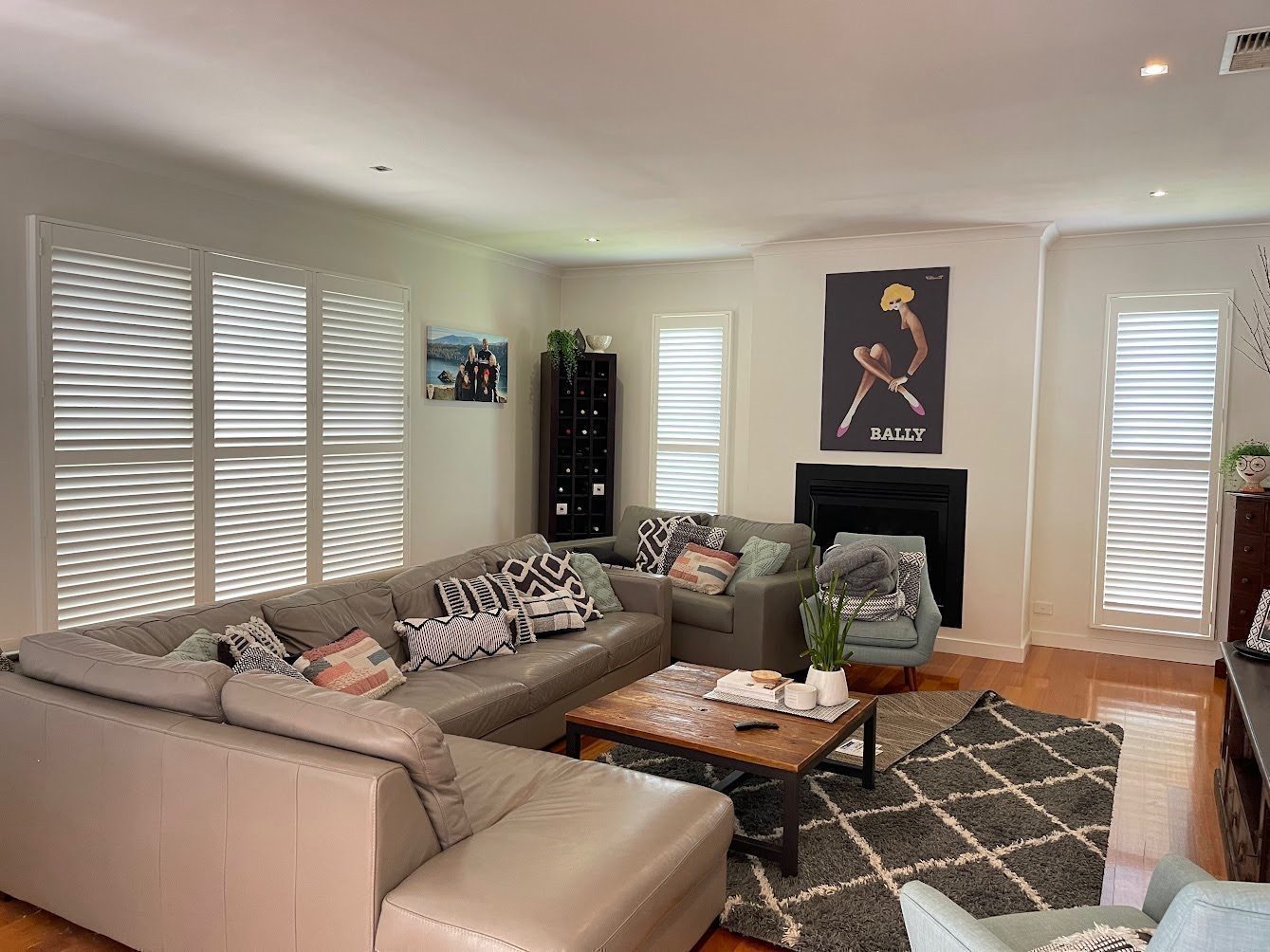 Plantation shutters with wide louvres custom made for a living area — Melbourne apartment