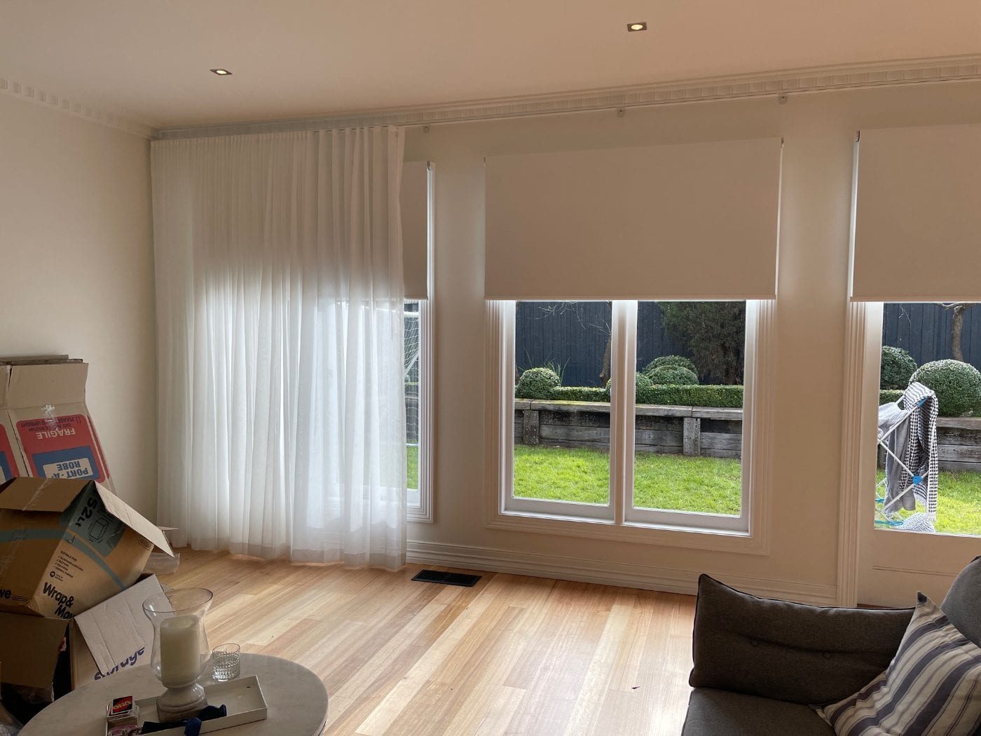 Double treatment with curtains and roller blinds in a Melbourne living and dining area