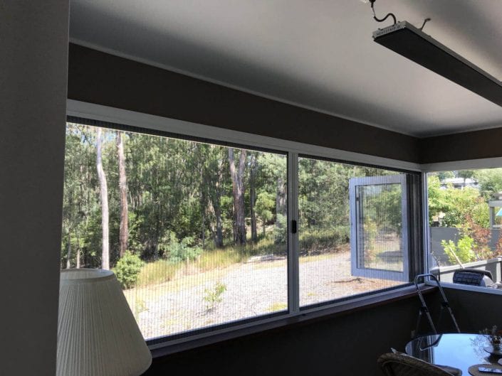 Retractable fly screens in a living room — Melbourne house