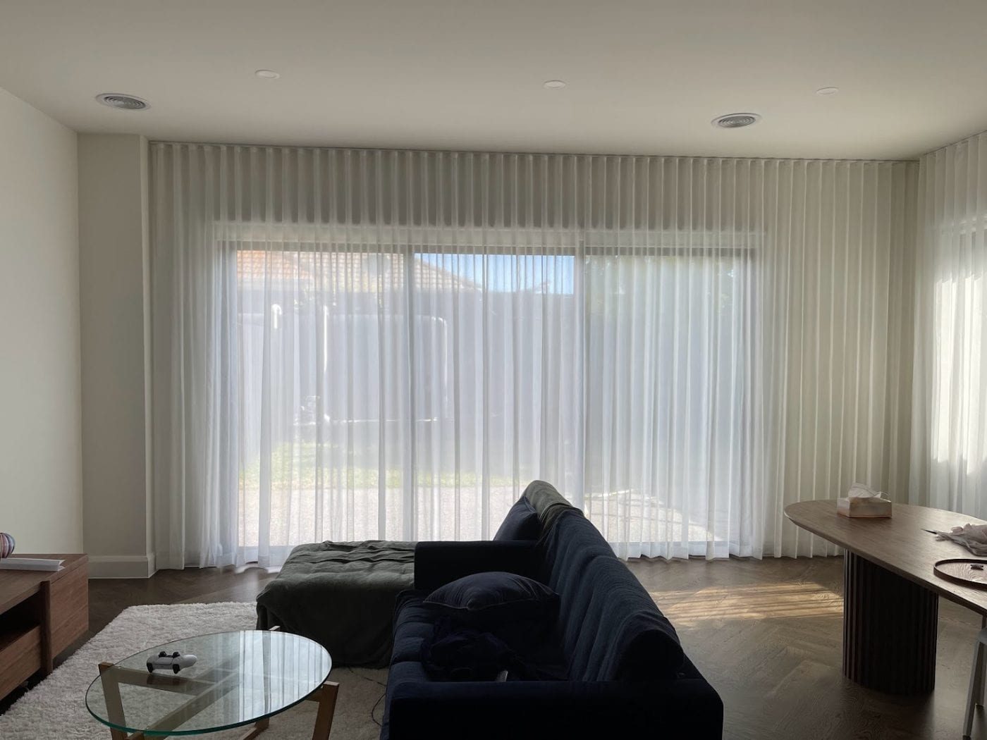 Pinch pleat curtains on full-height windows, Melbourne open-plan living