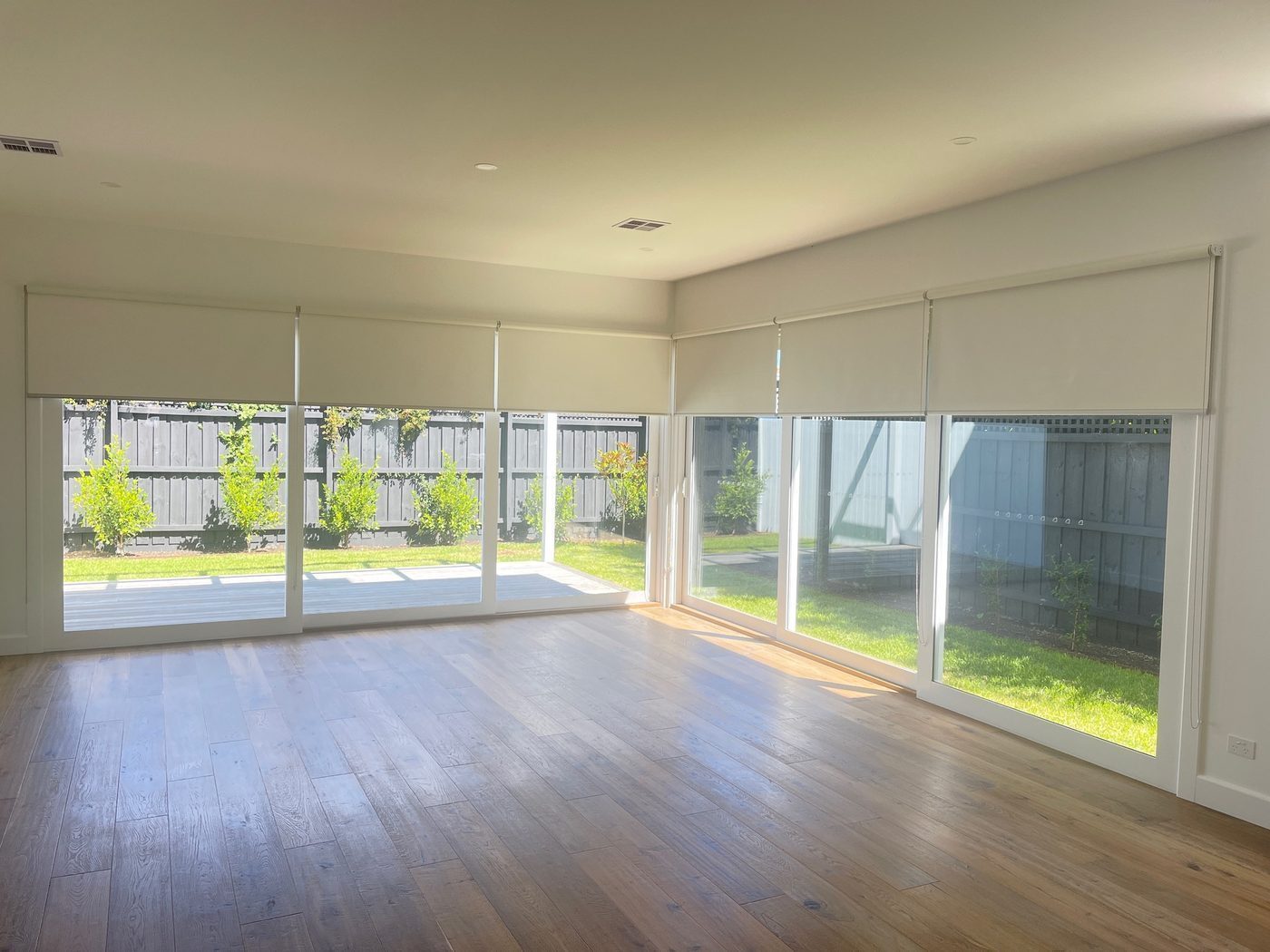 Double roller blinds fitted in a lounge room — Melbourne townhouse