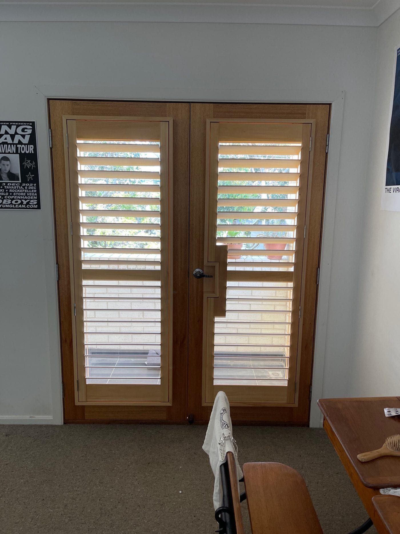 Plantation shutters on bay windows in a Melbourne living room
