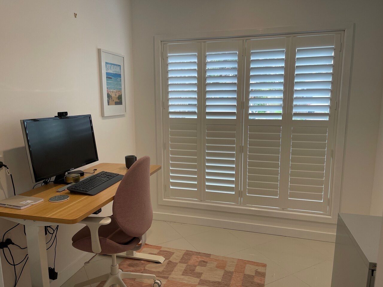 Plantation shutters with adjustable louvres in a Melbourne home study