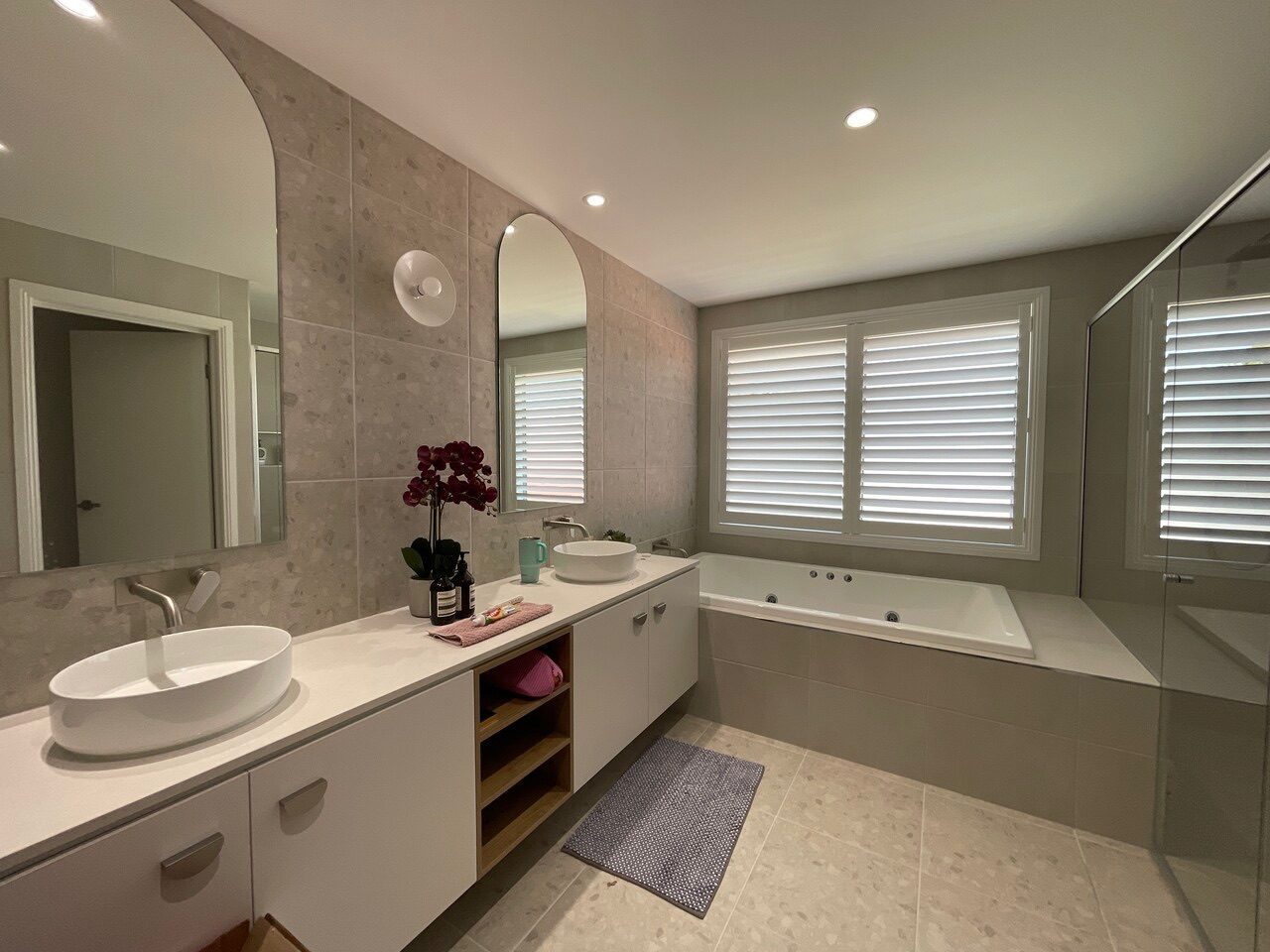 White plantation shutters fitted in a bathroom and ensuite — Melbourne residence