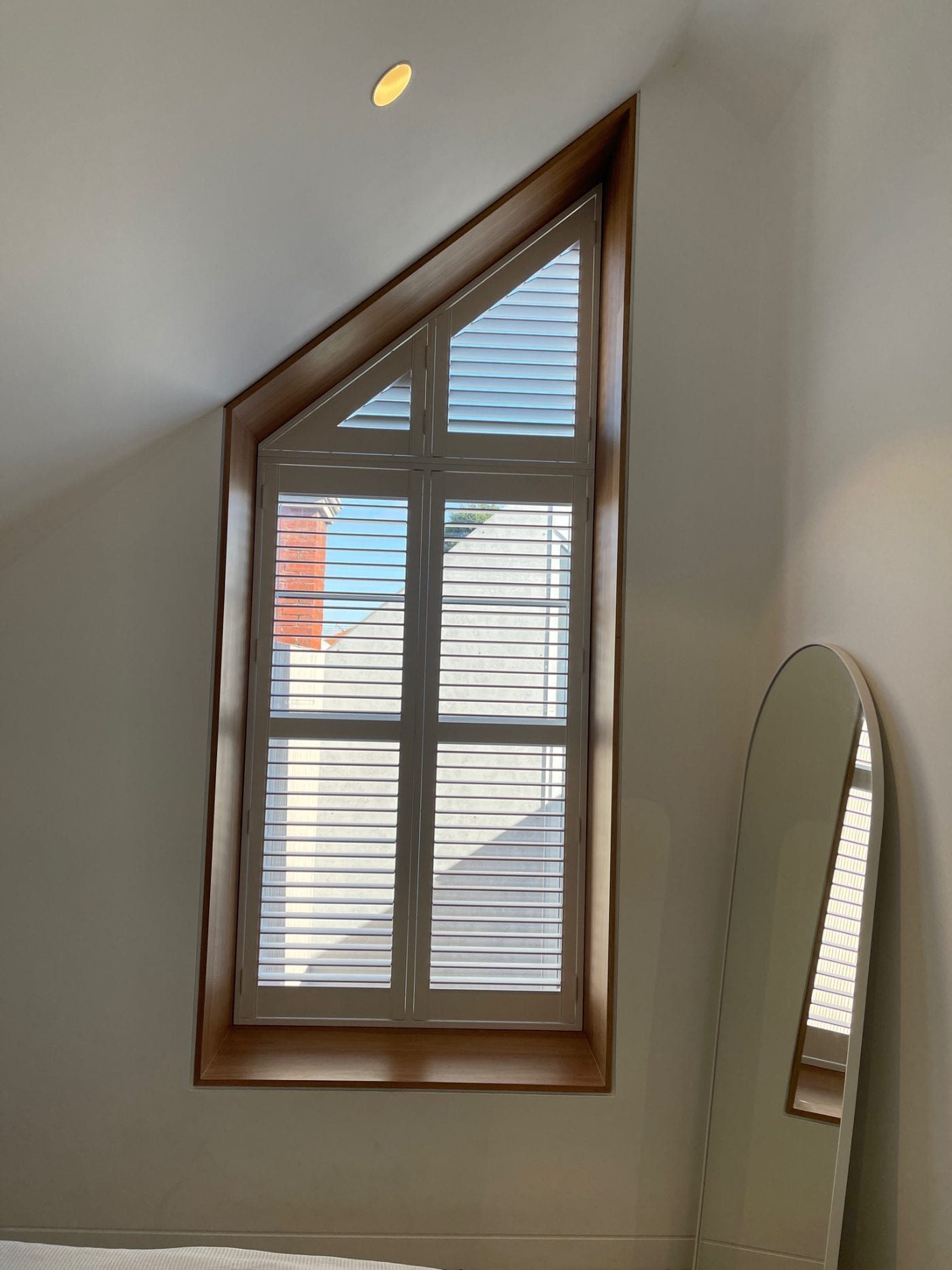 Timber-look plantation shutters in a contemporary Melbourne bedroom