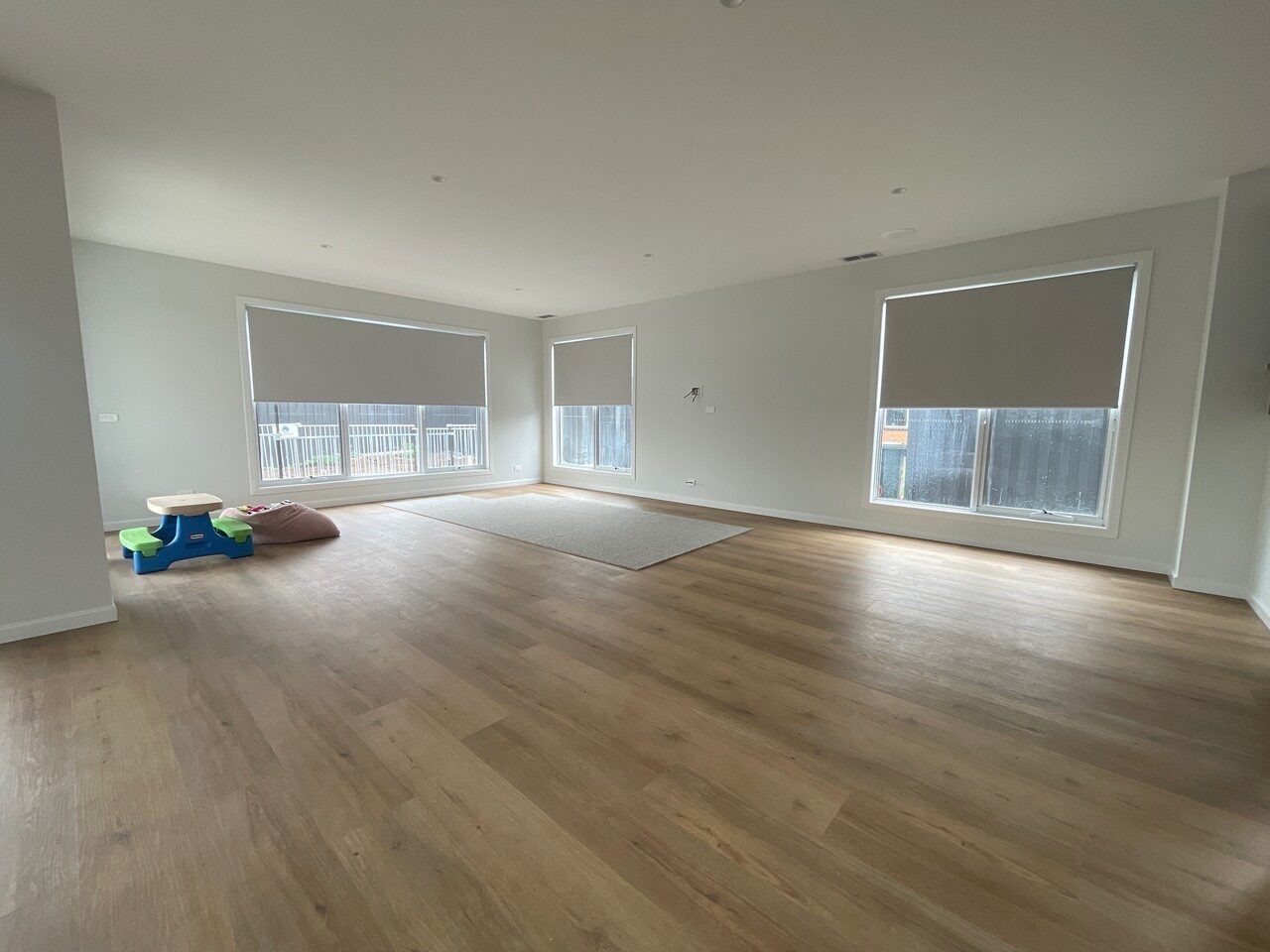 Roller blinds with side channels in a Melbourne open-plan space