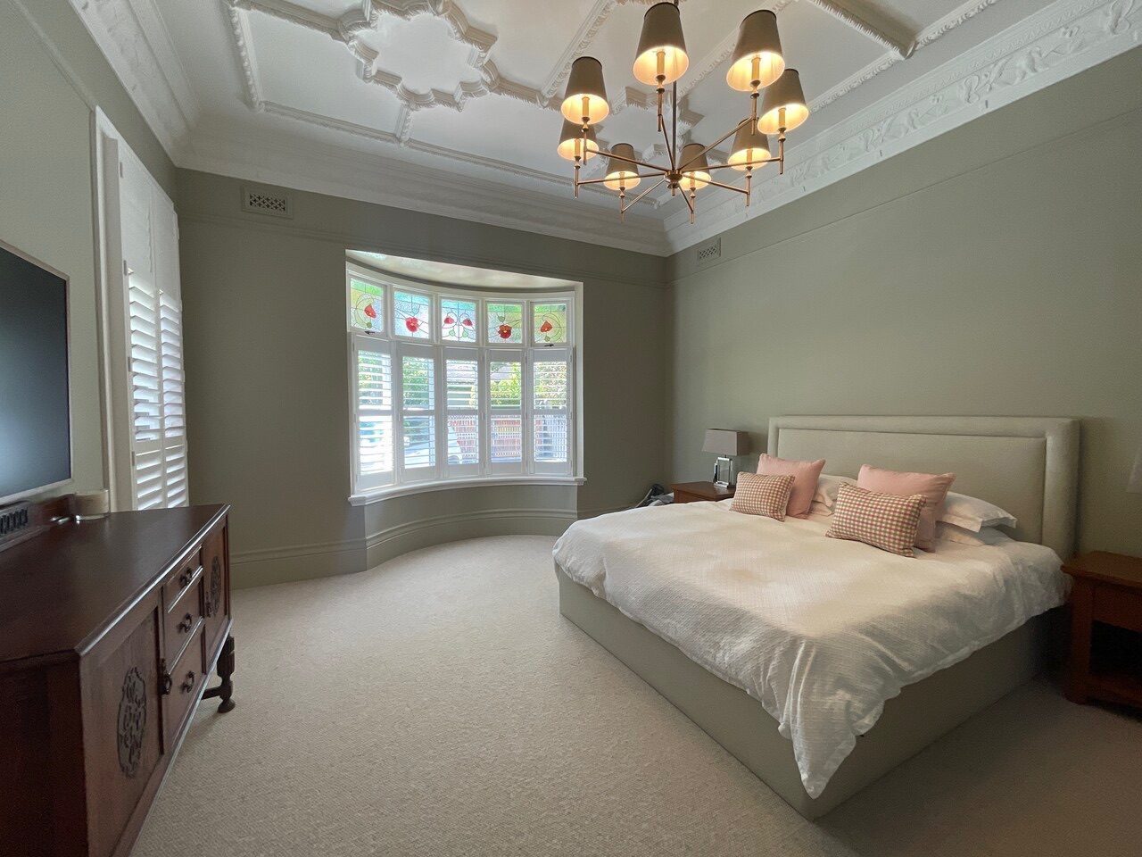Full-height plantation shutters in a bedroom — Melbourne townhouse