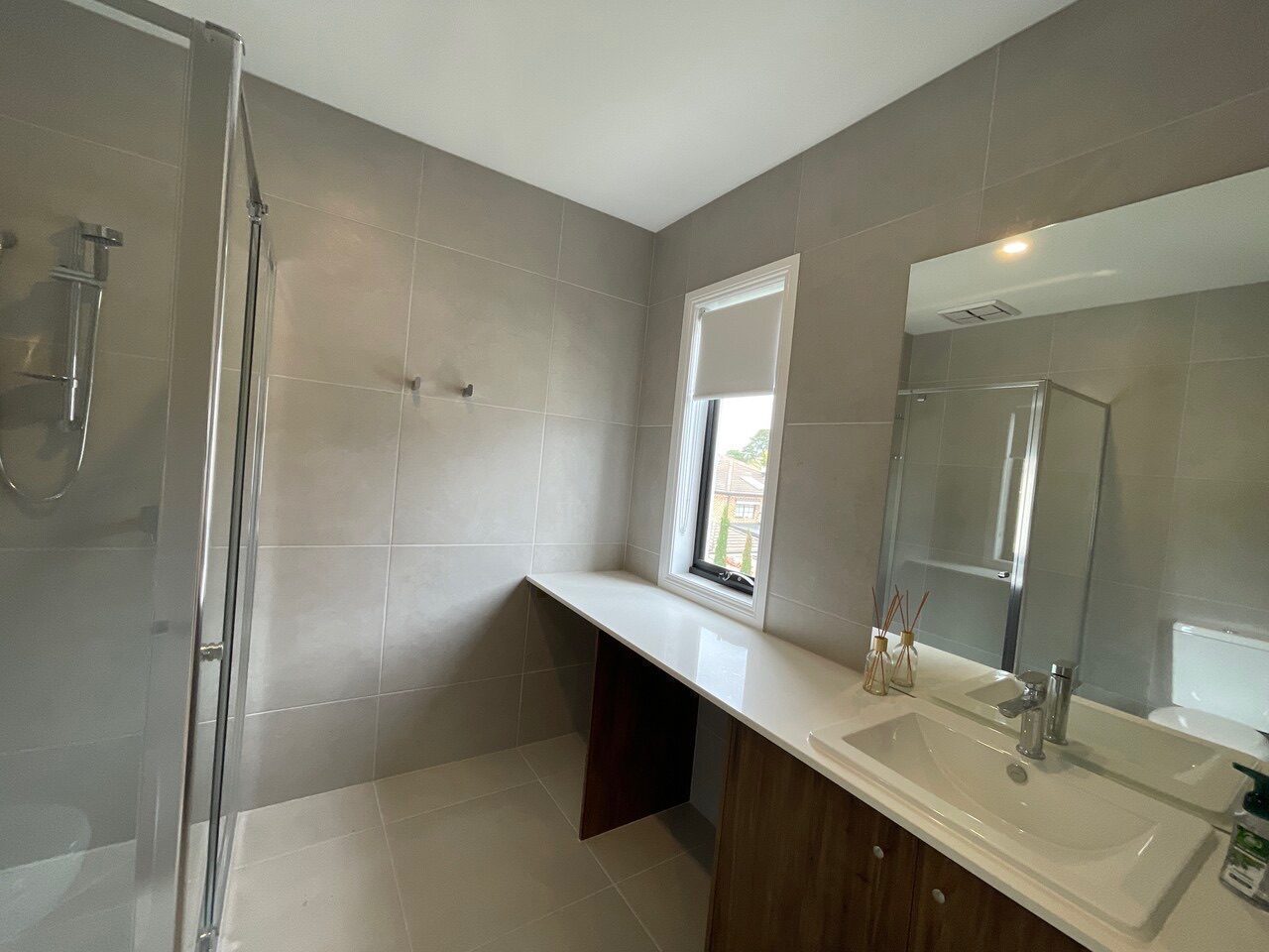 Full-height plantation shutters in a ensuite — modern Melbourne home