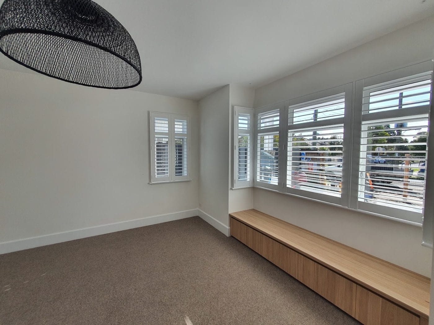 Custom plantation shutters with split tilt in a Melbourne bedroom