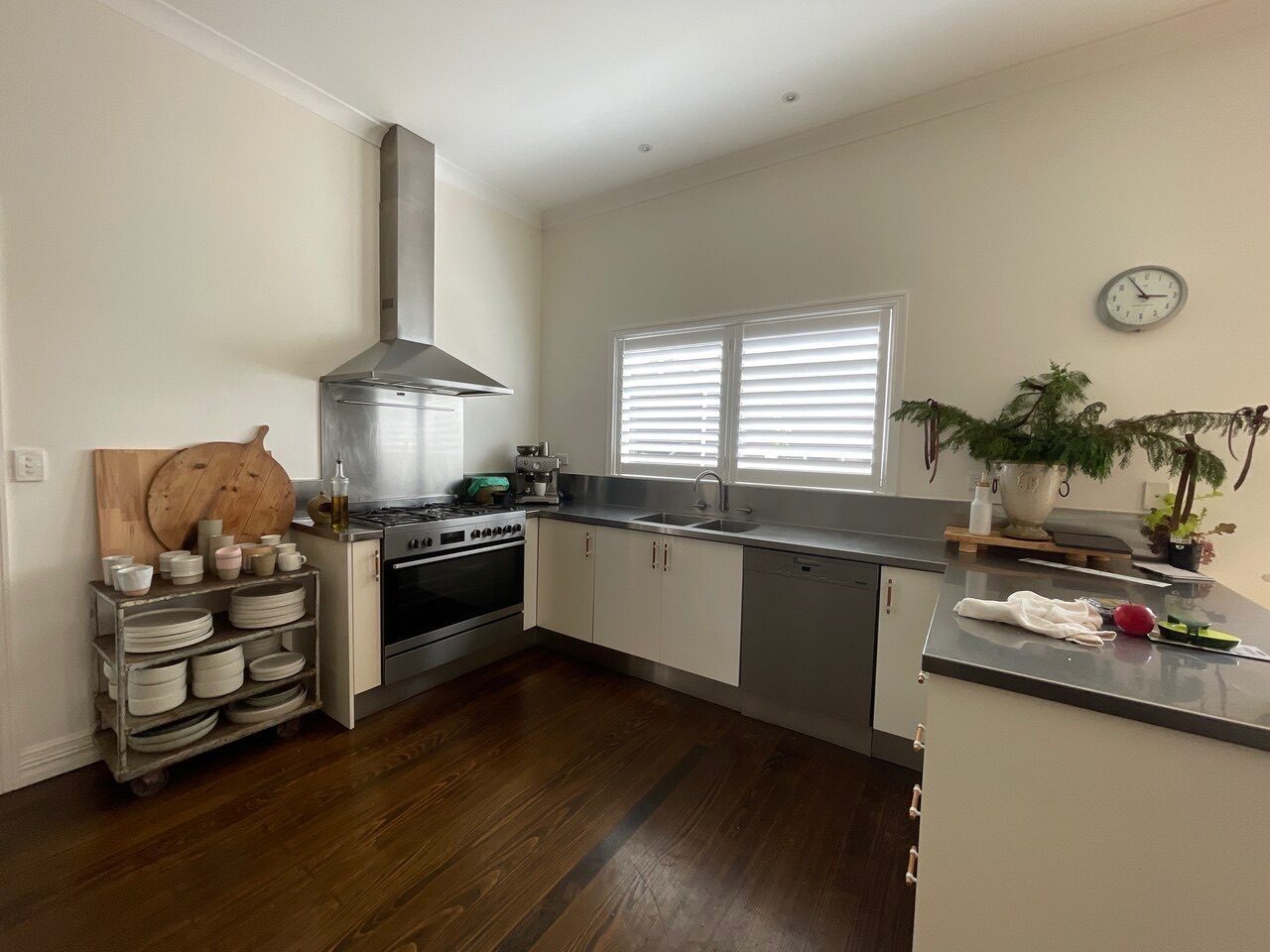 Plantation shutters with wide louvres custom made for a kitchen area — contemporary Melbourne home