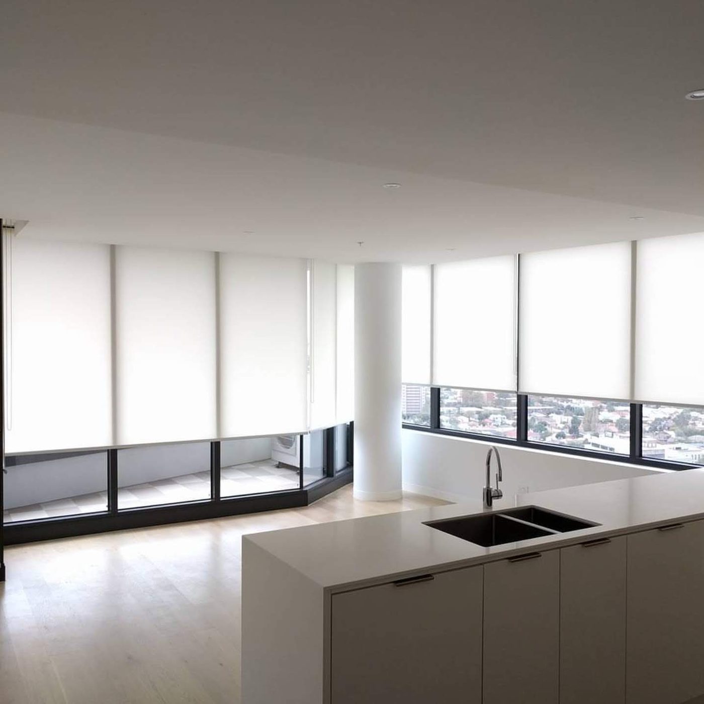 Fabric roller blinds installed in a living room — Melbourne apartment