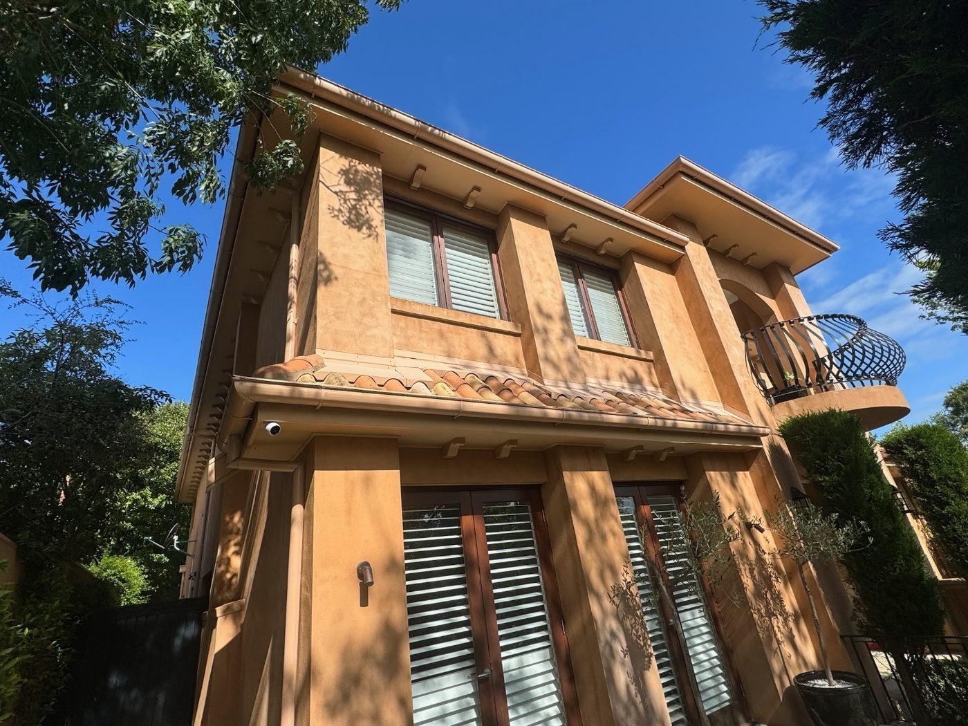 Custom plantation shutters on a double-storey Melbourne home exterior