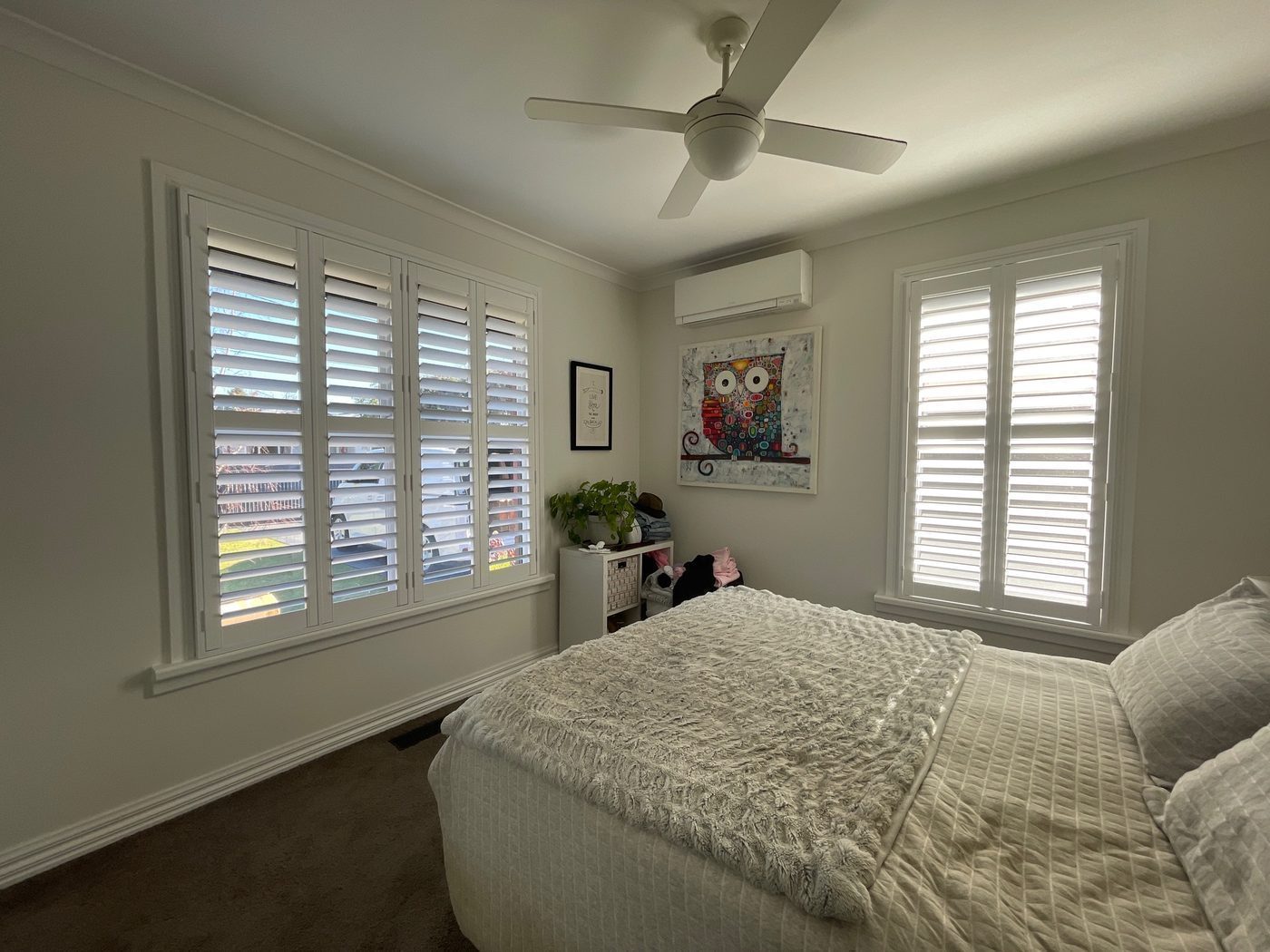 Bi-fold plantation shutters installed in a master bedroom — Melbourne home