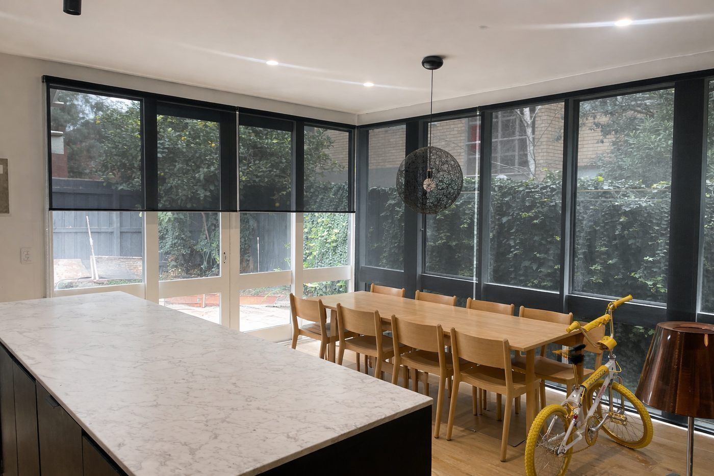 Double roller blinds fitted in a dining room — contemporary Melbourne home