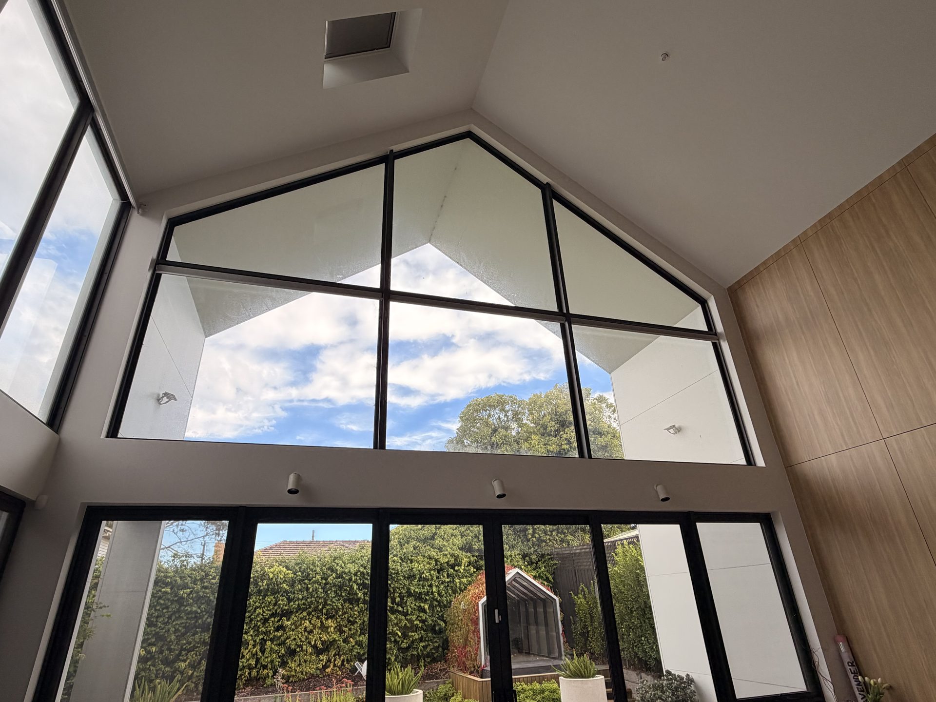 Motorised roller blinds high void windows living area Malvern Melbourne
